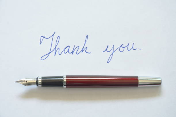 istock fountain pen and thank you word on white paper 896235278