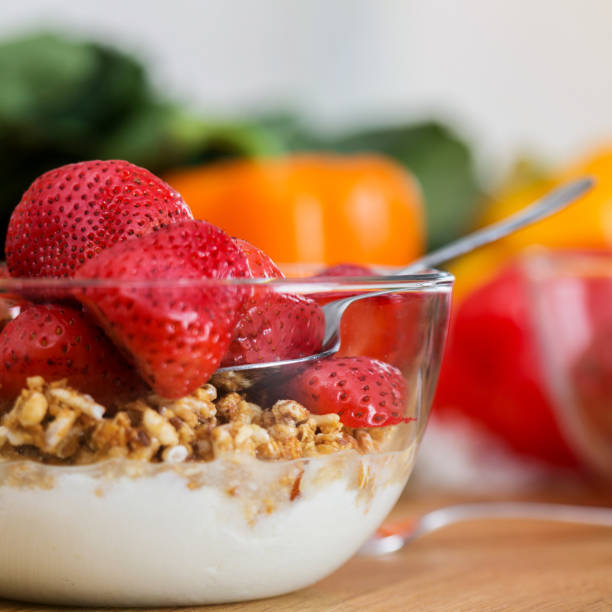 Fruit parfait with background of fresh veggies