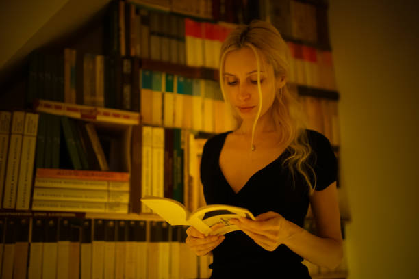 istock A young blonde girl reads a book. 896244092