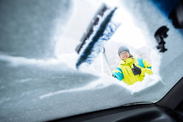istock man clean car of snow 896249876
