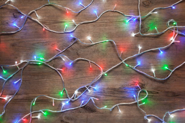 istock Christmas lights on wooden table 896250098