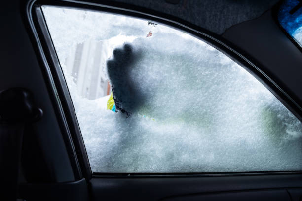 istock man clean car of snow 896250302