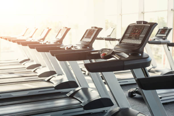 istock Modern gym interior equipment, treadmill control panels for card 896250314