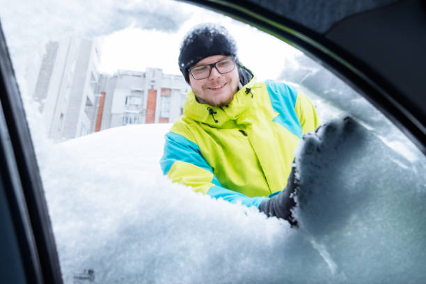 istock man clean car of snow 896250346