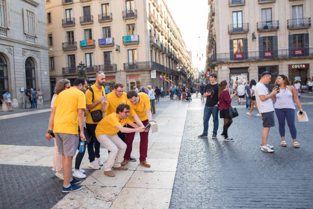 Company scavenger hunt in Gothic Quarter in Barcelona Barcelona, Spain, Oct. 13, 2017: Young employees on a company scavenger hunt, competing against other teams, wearing matching shirts, getting clues, meeting in Plaza Jaume in the Gothic Quarter. scavenger hunt stock pictures, royalty-free photos & images
