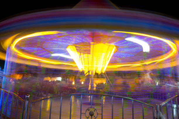 istock Round carousel in motion at night showing colorful lighting and movement 896254654