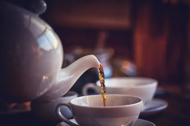 Photo of Cup of Black Tea Served with Biscuits