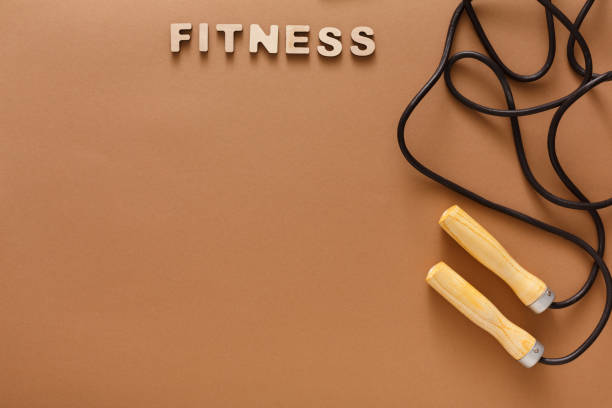 Fitness, jumping rope on black background