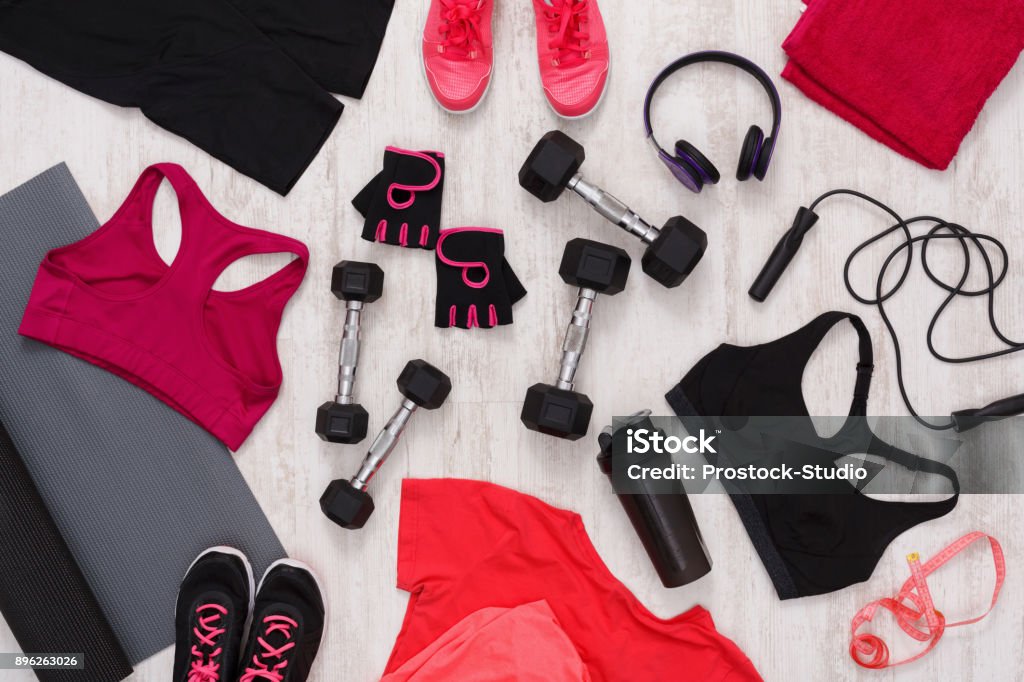 Female sport clothing and equipment top view Female sport clothing and equipment top view. Set of fitness outfit and accessories for women, active lifestyle, body care concept Sports Clothing Stock Photo