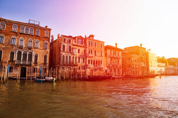 View of gondolas, architecture and canal in Venice, Italy at the sunset View of gondolas, architecture and canal in Venice, Italy at the sunset rialto california stock pictures, royalty-free photos & images