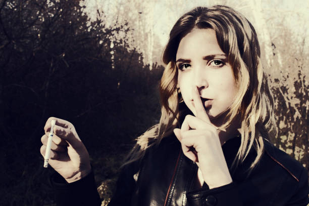 istock The girl asks no one to say that she smokes 896267394