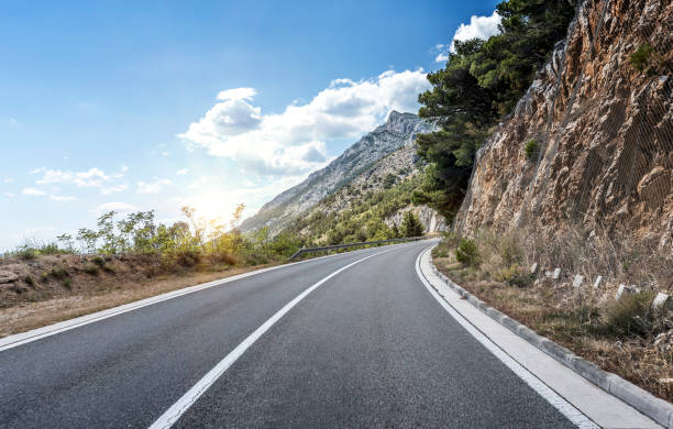 istock Country road through the rocky mountains and forest 896270392