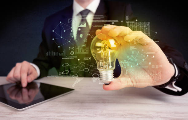 istock businessman holding glowing glass light bulb 896270630