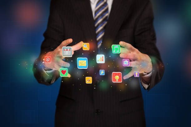 istock Businessman holding application icons 896270862