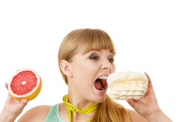 istock Woman choosing fruit or cake make dietary choice 896271016