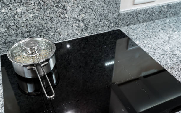 istock Stainless steel pan on modern induction hob or cooktop 896277580