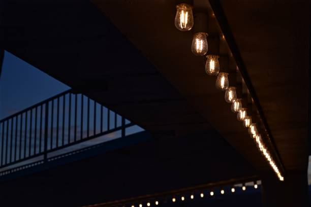 istock row of illuminated light bulbs in dark background 896277604