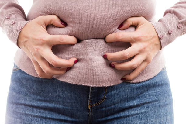 Woman grabbing her belly as painful abdominal problem Woman grabbing her belly as painful abdominal problem because of bloated tummy or premenstrual pain tetanospasmin stock pictures, royalty-free photos & images