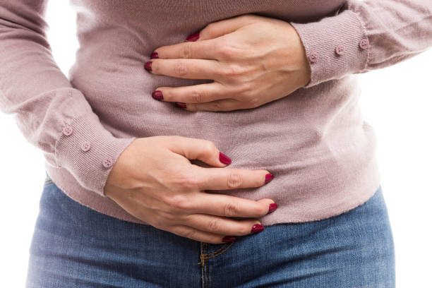 istock Woman holding her tummy as painful abdomen problem 896277908