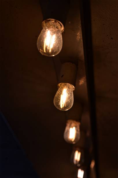 istock row of illuminated light bulbs in dark background 896278036