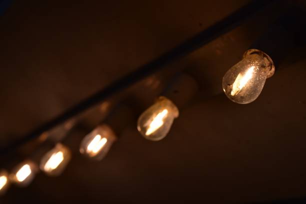 istock row of illuminated light bulbs in dark background 896278198