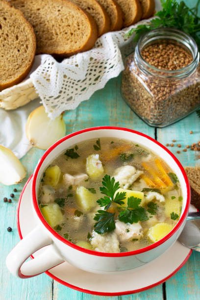 istock Homemade soup with buckwheat and pasta (dumplings) on the kitchen table. 896283296