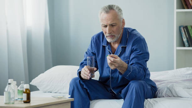 istock Male pensioner taking daily vitamin complex to maintain genitourinary system 896288246