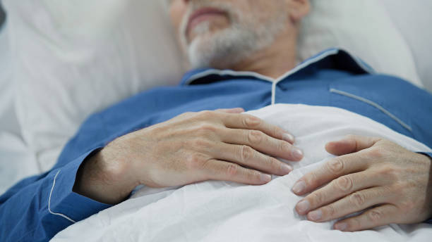 istock View of overworked wrinkled hands of wise old man peacefully drowsing in bed 896288812