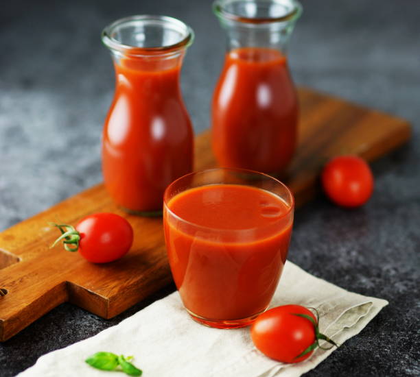 istock tomato juice in glass jars 896292044
