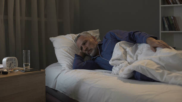 Pensioner impatiently waiting morning to come, suffering insomnia at night Pensioner impatiently waiting morning to come, suffering insomnia at night, stock footage Sleep Disturbances in Dementia stock pictures, royalty-free photos & images