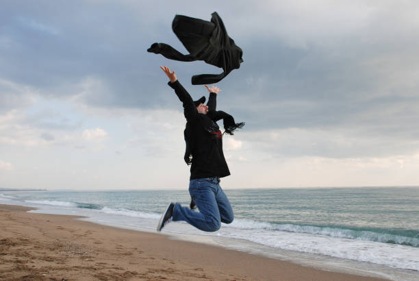 istock Man jumping at the beach  winter 896292420