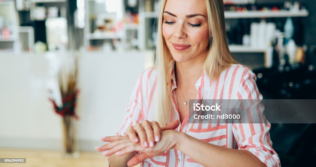 Woman applying moisturizing cream on hands Beautiful woman applying moisturizing cream on hands Hand Stock Photo