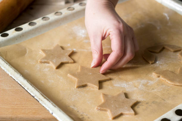 istock A woman rolls out the dough and cuts out the biscuits. 896299324