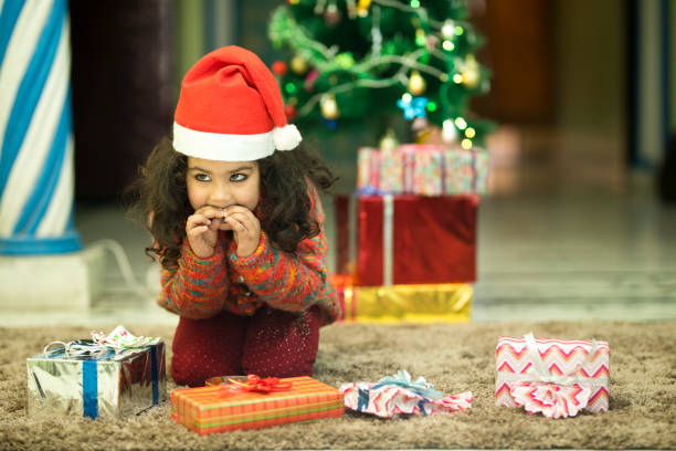 istock Little Santa girl eating candy 896324046