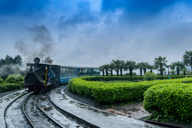 Toy Train May 01,2017.The Darjeeling Himalayan Railway, also known as the Toy Train, is a 2 ft narrow gauge railway,is entering to the Batasia loop,Darjeeling, west bengal, India. after a heavy rainfall. darjeeling stock pictures, royalty-free photos & images