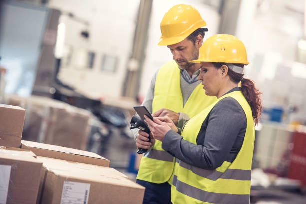 istock Warehouse manager showing plan to employee 896324872