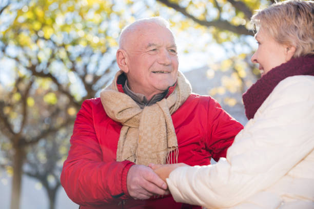 istock Mature couple talking in park 896333338