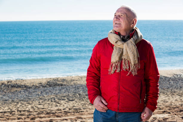 istock Mature man walking by sea 896335678