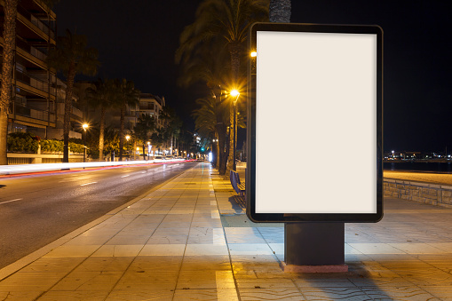 Blank advertisement mock up, in a footpath next to the sea at night