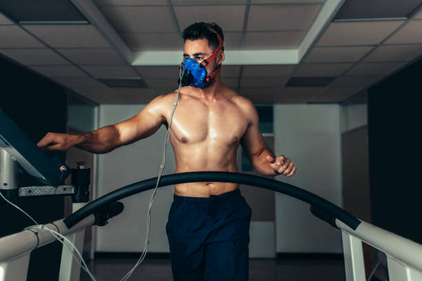 istock Professional athlete on treadmill monitoring his performance 896346070