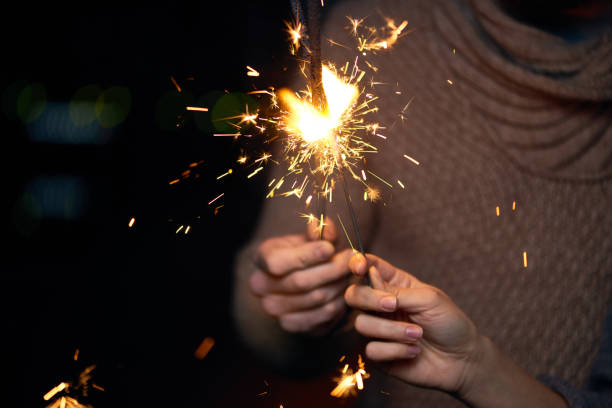 noite romântica do casal no ano novo - sparkler sparks new years eve human hand - fotografias e filmes do acervo