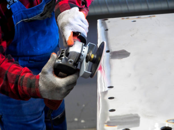 istock Metal polishing with a hand sander with a polishing disk 896348784