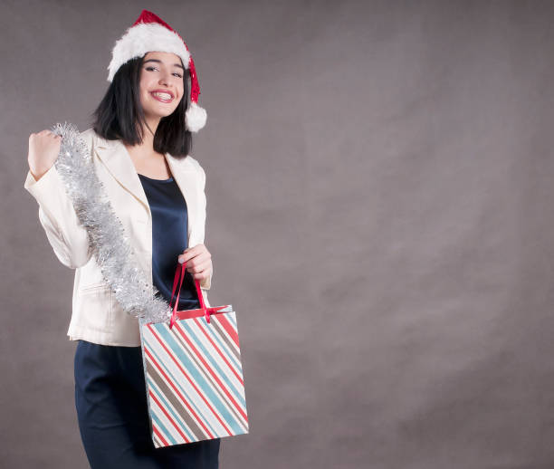 Woman in Santa Hat with Shopping Bag