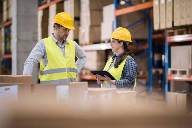 istock Male and female warehouse workers talking 896349054