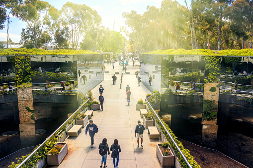 La Jolla, California, USA - April 3, 2017: The mirrored pathway to Geisel Library, the main library at the University of California, San Diego (UCSD), reflecting the students passing by.