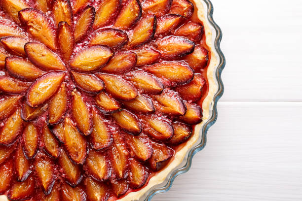 istock Homemade plum pie. Fruit tart on white table. Copy space. Top view. 896355486