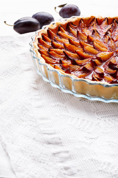 istock Homemade plum pie. Fruit tart on white table. Copy space. 896355624