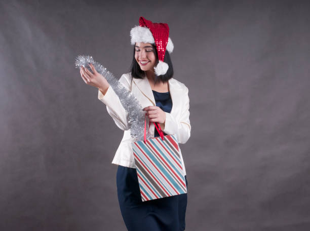 istock Woman in Santa Hat with Shopping Bag 896358376