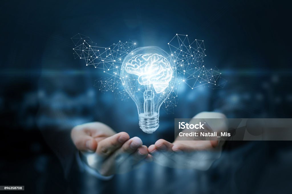Light bulb with brain inside the hands of the businessman. Light bulb with brain inside the hands of the businessman. The concept of the business idea. Innovation Stock Photo