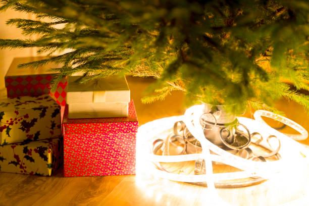 istock Christmas presents and lights under the evergreen christmas tree 896358802